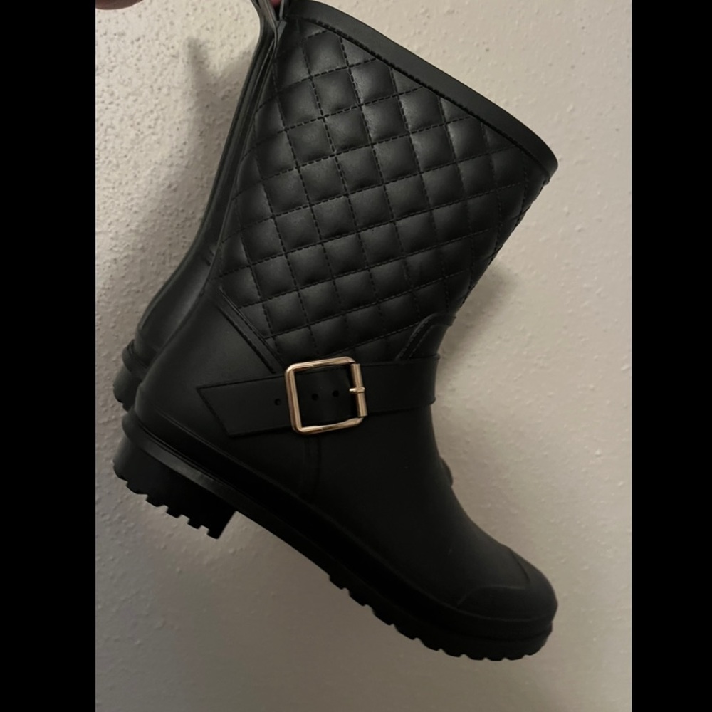 semi short black rain boots with gold detailing.